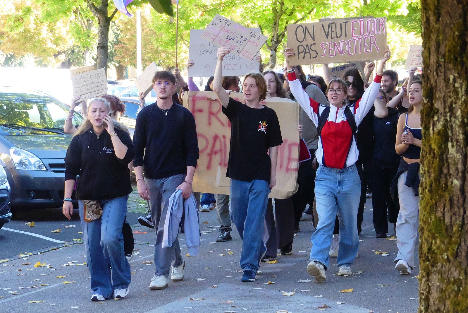 High-school students march through Belfort carrying placards, one reading 'On veut étudier pas s'endetter' (We want to study, not get into debt).