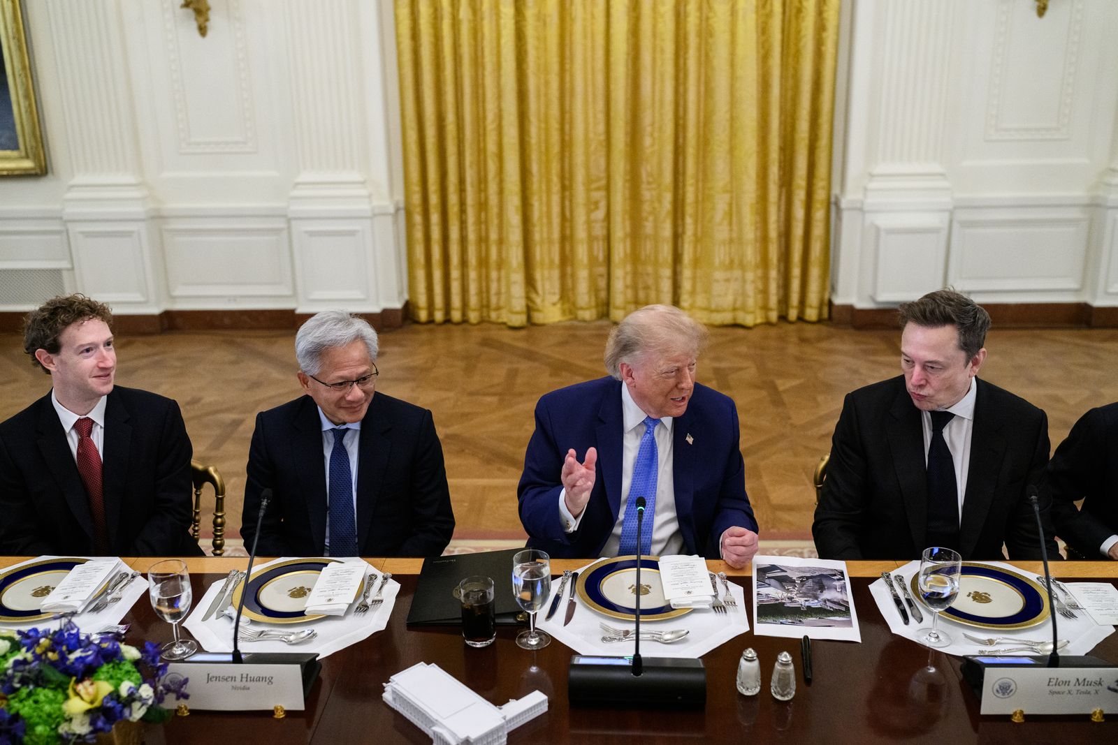 President Trump at a long dining table in the East Room, seated between technology executives