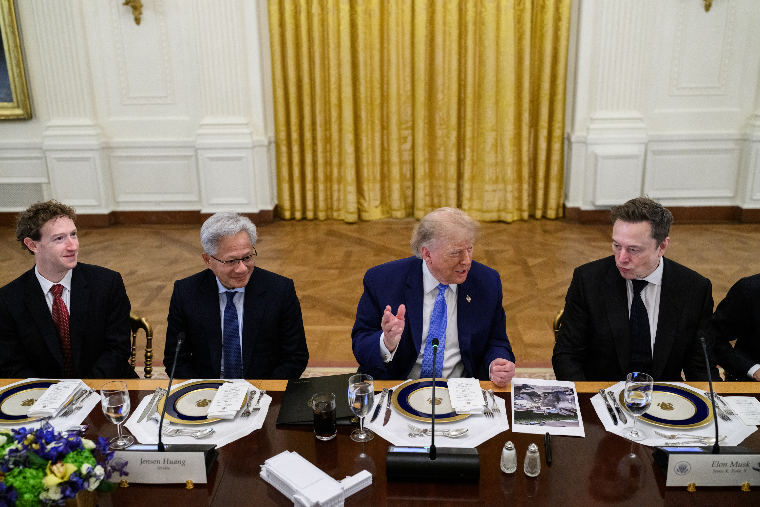President Trump at a long dining table in the East Room, seated between technology executives