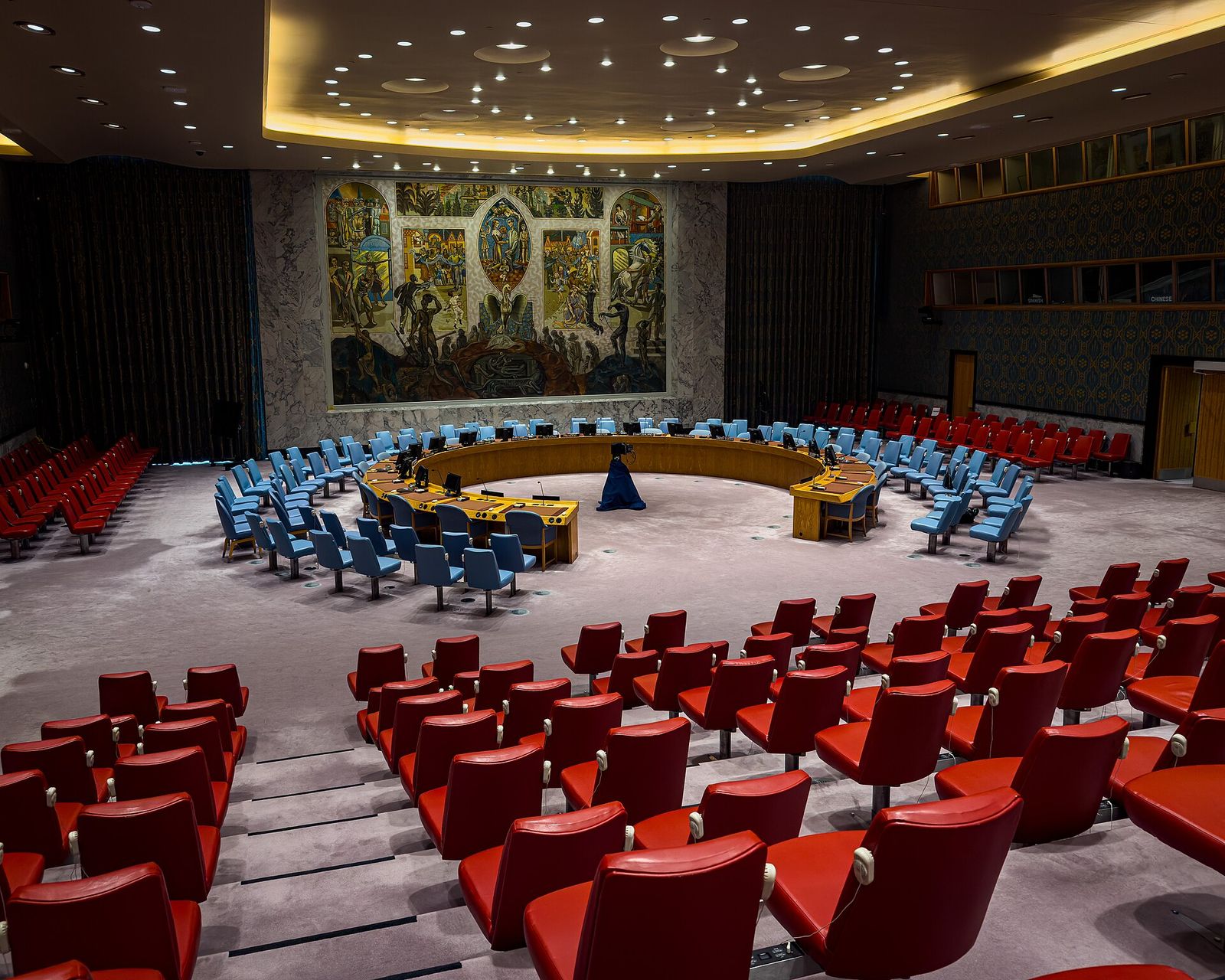The UN Security Council chamber in New York, with its horseshoe table and mural