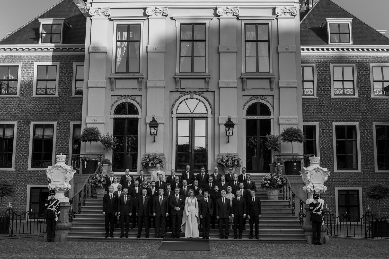 NATO leaders stand in rows for the family photo at the 2025 summit in The Hague, in front of the Huis ten Bosch Palace.