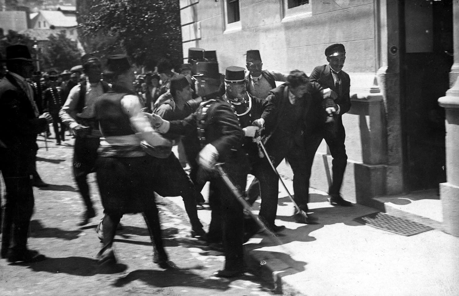 Police and soldiers in Sarajevo seize a man in the street after the assassination of Archduke Franz Ferdinand, June 1914.