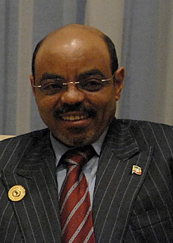 Meles Zenawi, smiling, in glasses and a pinstriped suit