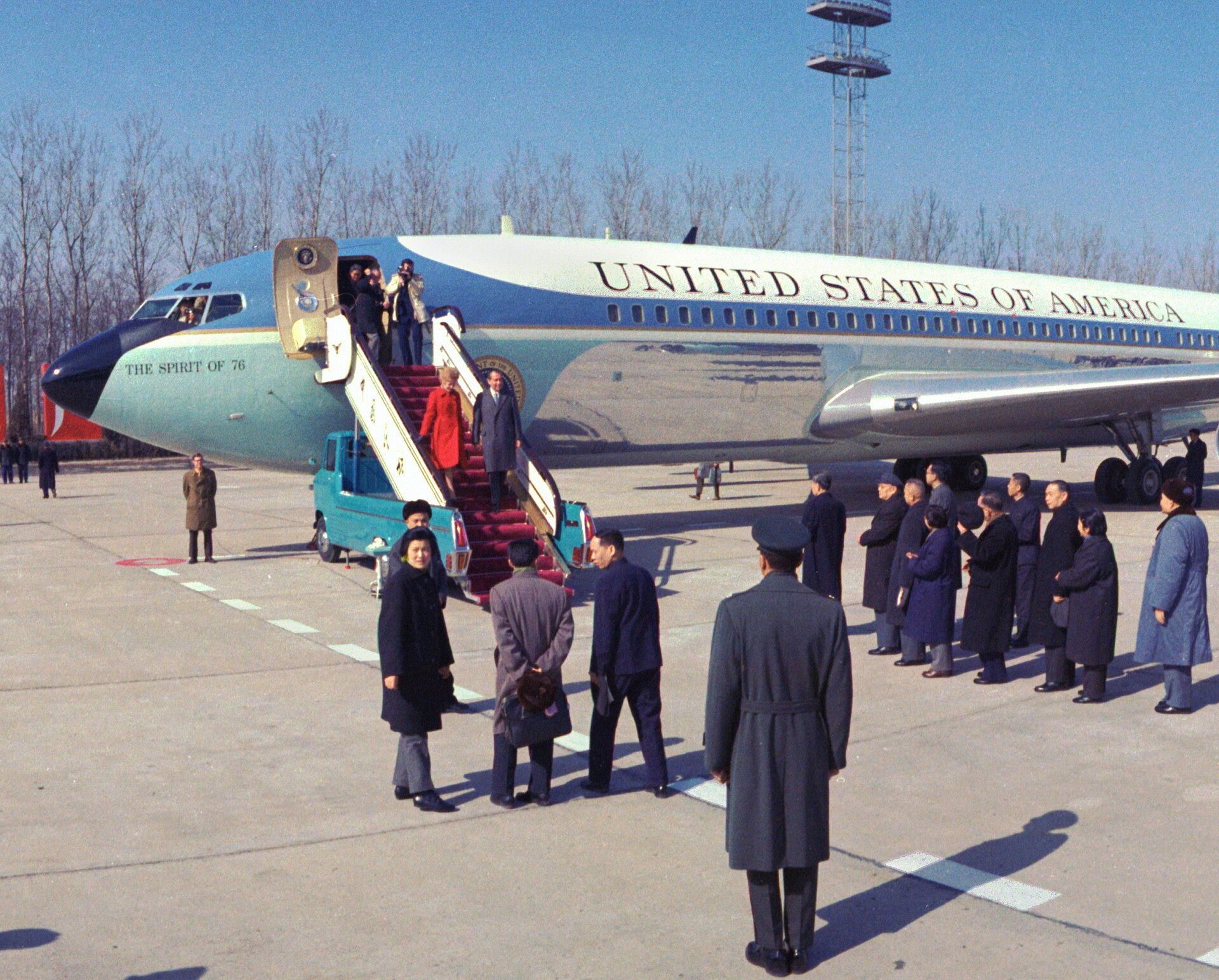 President Richard Nixon and Pat Nixon walking down the steps of Air Force One on arrival in China