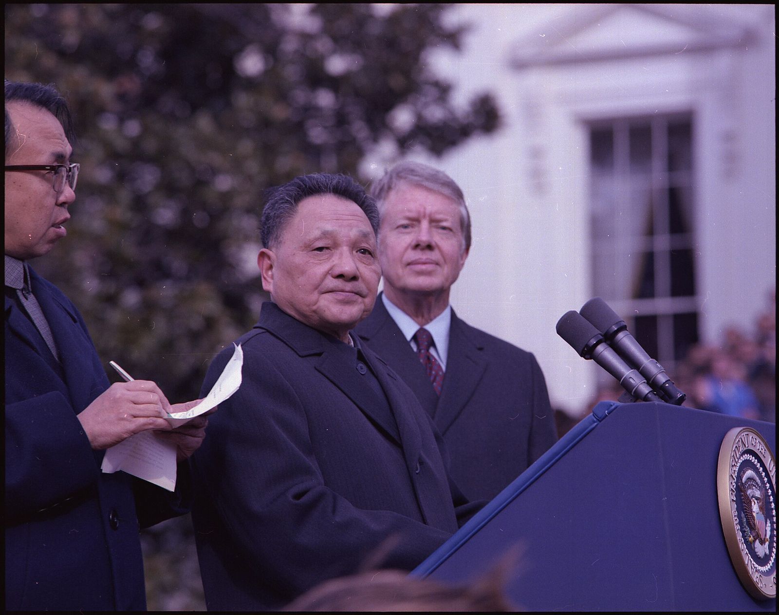Deng Xiaoping and President Jimmy Carter standing together at an outdoor arrival ceremony