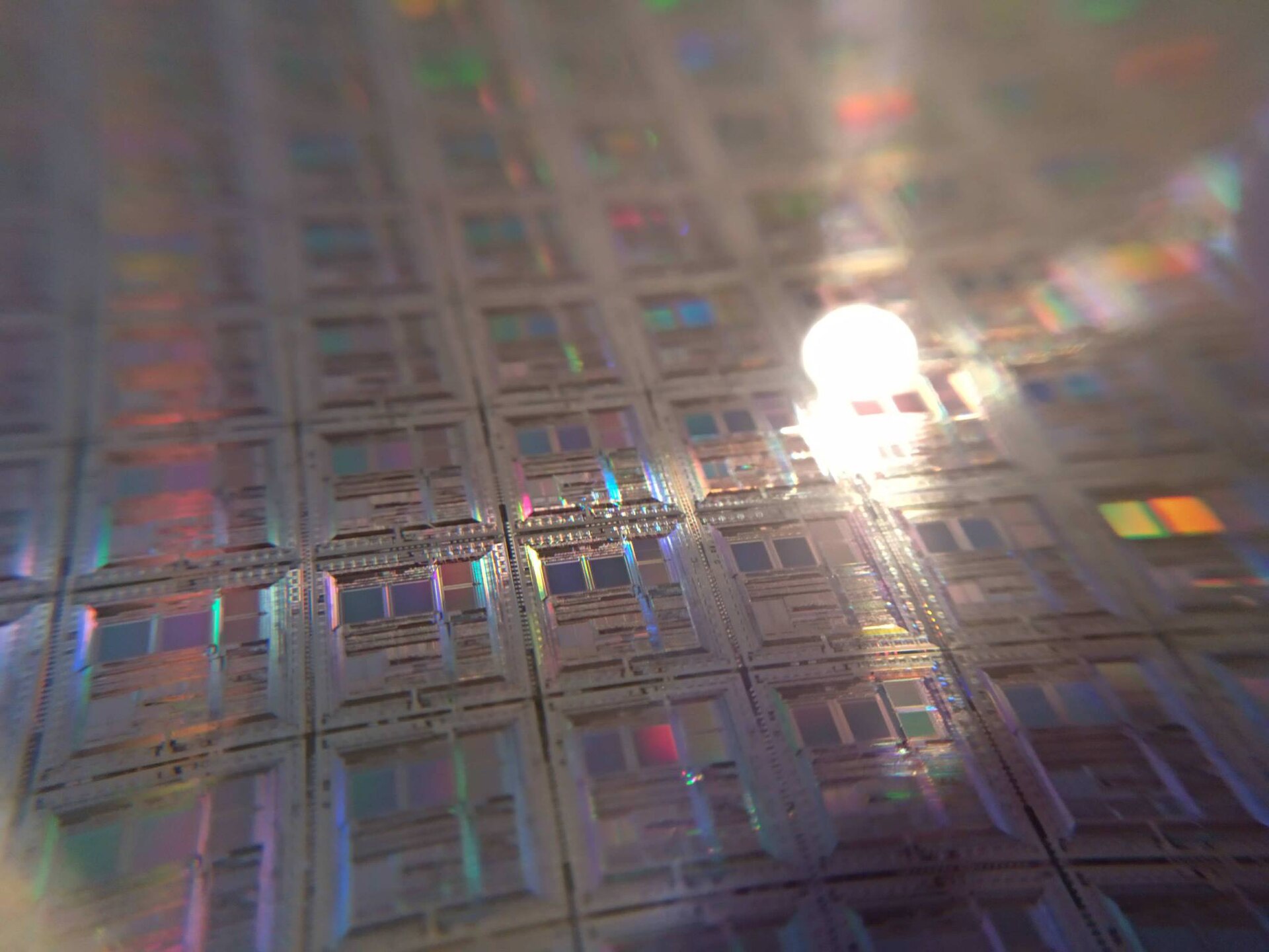 Close view of a silicon wafer patterned with rows of chips